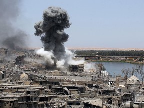 A picture taken on July 9, 2017, shows smoke billowing following an airstrike by US-led international coalition forces targeting Islamic State fighters in Mosul.