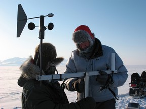 1st Canadian Ranger Patrol Group Commanding Officer Major Luc Chang assists International Polar Year scientist Dr Luke Copland, Assistant Professor at the University of Ottawa, as he sets up his equipment on the Alfred Ernest Ice Shelf, Ellesmere Island, Nunavut.