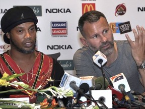 Manchester United legend Ryan Giggs, right, speaks next to Brazilian soccer star Ronaldinho, during a press conference in Lahore, Pakistan, Sunday, July 9, 2017. Ronaldinho and Giggs were among the soccer stars that arrived in Pakistan to play exhibition matches which organizers hope will boost the sport in the country. (AP Photo/K.M. Chaudary)