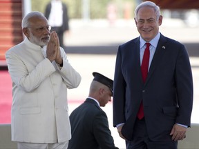 Indian Prime Minister Narendra Modi left, and Israeli Prime Minister Benjamin Netanyahu stand during welcome ceremony upon arrival in Ben Gurion airport near Tel Aviv, Israel, Tuesday, July 4, 2017. (AP Photo/Ariel Schalit)