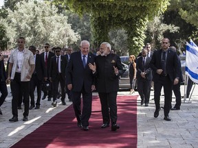 Israel's President Reuven Rivlin, left, walks with Indian Prime Minister Narendra Modi during a welcome ceremony in Jerusalem Wednesday, July 5, 2017. Modi is on a high-profile visit to Israel aimed at celebrating 25 years of diplomatic relations and strengthening his country's already warm ties with the Jewish state. (AP Photo/Tsafrir Abayov)