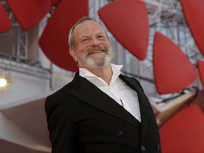 FILE - In this file photo dated Monday, Sept. 2, 2013, movie director Terry Gilliam arrives for the screening of his movie 'The Zero Theorem' at the 70th edition of the Venice Film Festival in Venice, Italy. Portuguese authorities have rejected a television program's claims that one of the country's most cherished historic monuments, the 12th-century Convent of Christ, was damaged during the shooting of the film  "The Man Who Killed Don Quixote." by director and former Monty Python star Terry Gilliam. (AP Photo/Andrew Medichini, FILE)
