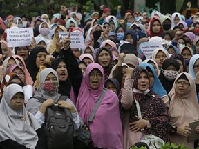 Indonesian Muslims shout "Allahuakbar!' (God is great) during a rally in Jakarta, Indonesia, Tuesday, July 18, 2017. Muslim hardliners staged the rally denouncing a decree signed by President Joko Widodo earlier this month that could give the the government almost unfettered power to ban radical groups it deems contrary to the country's constitution. (AP Photo/Achmad Ibrahim)