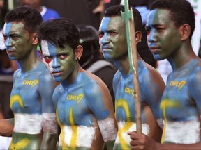 In this Tuesday, July 17, 2017 supporters of CNRT Party have their face and body painted with the party's colors during a campaign rally in Dili, East Timor. Almost two dozen parties are contesting parliamentary elections in East Timor on the weekend that are likely to return independence heroes to power despite increasing frustration in the young democracy with lack of economic progress and warnings the country could be bankrupt within a decade. (AP Photo/Kandhi Barnez)
