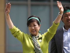 In this Thursday, June 29, 2017 photo, Tokyo Gov. Yuriko Koike waves to a crowd during her "Tomin (Tokyoites) First" party's campaign rally for Tokyo Metropolitan Assembly election in Tokyo. Tokyo residents were voting for the city's assembly in an election Sunday, July 2,  2017, that could alter national politics as the populist governor Koike aims to strengthen her base and challenge Prime Minister Shinzo Abe's scandal-laden ruling party.   (AP Photo/Shuji Kajiyama)