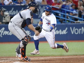 Russell Martin of the Toronto Blue Jays makes his way to home plate while Houston Astros' Brian McCann waits for the throw during MLB action Thursday night at Rogers Field. The Jays were 7-4 winners, their third straight victory.