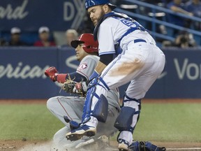 Los Angeles Angels' Yunel Escobar is tagged out by Toronto Blue Jays catcher Russell Martin on a play at home plate during MLB action Friday night at Rogers Centre. The Angels were 7-2 winners, snapping the Jays' win streak at four games.