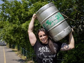 Allison Lockhart, Canada's strongest woman, who will be competing this weekend at the Calgary Stampede, carries a beer keg while training at the Stampede in Calgary, Alta., Wednesday, July 12, 2017.THE CANADIAN PRESS/Jeff McIntosh