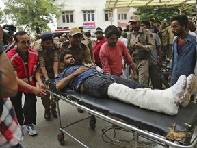 An Indian Hindu pilgrim injured in a bus accident is brought for treatment at a hospital in Jammu, India, Sunday, July 16, 2017. A bus plunged into a 45-meter-deep (150-foot-deep) gorge in the Indian portion of Kashmir on Sunday, killing at least 16 Hindu pilgrims on their way to a cave shrine in the Himalayas. (AP Photo/Channi Anand)