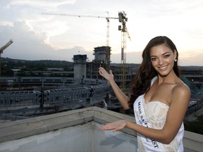 FILE -- in this Feb. 2, 2017, file photo Miss South Africa, Demi-Leigh Nel-Peters, in Pretoria, South Africa. A beaming Miss South Africa was photographed with children at a soup kitchen in what was supposed to be a feel-good charity event. But she ended up fending off accusations of racism for wearing gloves while interacting with black children. (AP Photo)