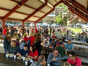 In a photo provided by Bret Howser, people attend a pancake breakfast in Brian Head, Utah on Tuesday, July 4, 2017, that volunteers and residents put on for local firefighters who've been fighting a wildfire that forced the evacuation of the town for nearly two weeks.  (Bret Howser via AP)