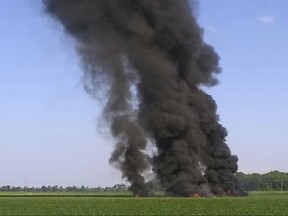 In this photo provided by Jimmy Taylor, smoke and flames rise into the air after a military transport airplane crashed in a field near Itta Bena, Miss., on the western edge of Leflore County, Monday, July 10, 2017, killing several. (Jimmy Taylor via AP)