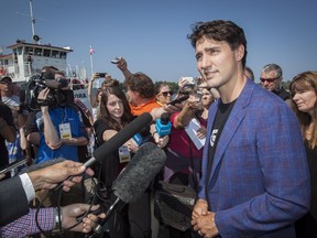 Prime Minister Justin Trudeau speaks with members of the media on the waterfront during a visit to Kenora, Ont., on Friday, July 28, 2017. THE CANADIAN PRESS/Tom Thomson