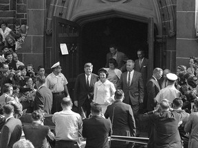 FILE - In this Oct. 1, 1961 file photo, President John F. Kennedy and first lady Jacqueline Kennedy leave St. Mary's Church in Newport, R.I., after Mass. The Rhode Island church, where the Kennedys wed on Sept. 12, 1953, is inviting visitors in to kneel where the couple knelt, listen to the music that played and imagine the day. (AP Photo/File)