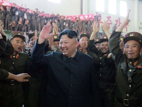 North Korean leader Kim Jong-Un celebrating the successful test-fire of the intercontinental ballistic missile Hwasong-14 at an undisclosed location.