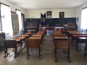 This photo shows the classroom in the Sunnyside School, a rural school depicting school life from the late 19th century. The deteriorating log cabin at the "Little House on the Prairie" site in Kansas is expected to soon get a makeover. The current cabin was re-created and built near Independence in 1977 at the television series' peak of popularity. The show is based off Laura Ingalls Wilder's books centered on her childhood in the country's Midwest region.. (Beccy Tanner/The Wichita Eagle via AP)