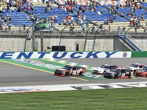 Xfinity Series driver Kyle Busch (18) leads the pack across the line to start the NASCAR Xfinity auto race at Kentucky Speedway, Saturday, July 8, 2017, in Sparta, Ky. (AP Photo/Timothy D. Easley)
