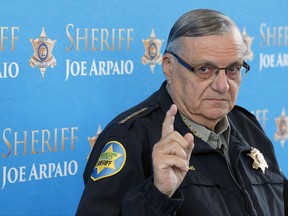 FILE - In this Dec. 18, 2013 file photo, Maricopa County Sheriff Joe Arpaio pauses as he answers a question at a news conference at Maricopa County Sheriff's Office Headquarters in Phoenix. Arpaio was convicted of a criminal charge Monday, July 31, 2017, for refusing to stop traffic patrols that targeted immigrants, marking a final rebuke for a politician who once drew strong popularity from such crackdowns but was ultimately booted from office as voters became frustrated over his headline-grabbing tactics and deepening legal troubles. (AP Photo/Ross D. Franklin, File)