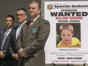 FILE - In this May. 17, 2017, file photo, Los Angeles County Sheriff's Department Homicide Bureau Capt. Christopher Bergner, center, stands by a poster of Aramazd Andressian Jr., a 5-year-old boy who had been missing for several weeks from South Pasadena, Calif., at a news conference outside the Hall of Justice in Los Angeles. Mourners including the boy's devastated mother gathered at a funeral service for the boy who police say was killed by his father after a family trip to Disneyland. The private funeral for Andressian was held Tuesday, July 18, at a church in South Pasadena. (AP Photo/Damian Dovarganes, File)