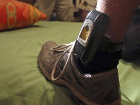 FILE - This Aug. 3, 2009, file photo shows a GPS locater worn on the ankle of a parolee in Rio Linda, Calif. Legal scholars say stringent rules in California for juvenile offenders who are required to wear GPS monitoring bracelets are cycling children back behind bars for minor infractions. A report being released Wednesday, July 12, 2017, by the University of California, Berkeley, and the East Bay Law Center found "unrealistically onerous" policies after an examination of 58 counties. (AP Photo/Rich Pedroncelli, File)