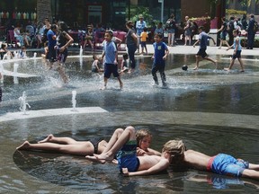 Children out of school for the summer take advantage of the Grand Park fountain in downtown Los Angeles on Wednesday, July 5, 2017. Forecasters say a new heat wave is setting in across the interior of Southern California, and the southern Sierra Nevada is facing a period of elevated fire danger. The National Weather Service says the heat is coming from high pressure building over the desert Southwest that will expand westward. (AP Photo/Richard Vogel)