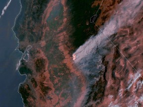 This satellite imagery, posted Wednesday, July 19, 2017 on a National Oceanic and Atmospheric Administration website, shows a large plume of smoke spreading hundreds of miles east from the Ditwiler fire, near Yosemite National Park in California's Sierra Nevada. Authorities say the stubborn wildfire burning in foothills west of Yosemite had destroyed dozens of structures while forcing thousands of people from their homes Wednesday. The San Francisco Bay Area is at left; Lake Tahoe is at top center. (National Oceanic and Atmospheric Administration via AP)