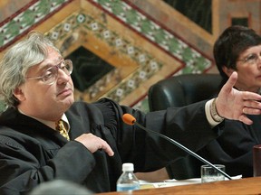 FILE - In this Sept. 22, 2003, file photo, Judge Alex Kozinski, of the 9th U.S. Circuit Court of Appeals, gestures as Chief Judge Mary Schroeder looks on in San Francisco. The nation's largest federal court circuit is set for its annual meeting after a contentious six months that has seen its judges repeatedly clash with President Donald Trump, and its agenda is not shying away from topics that have stoked the president's ire. Immigration, the news media and meddling in the U.S. election are among the subjects that will be discussed at the 9th Circuit's four-day conference in San Francisco that begins on Monday, July 17, 2017. (AP Photo/Paul Sakuma, Pool, File)