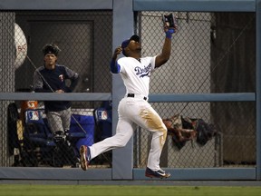 Los Angeles Dodgers' Yasiel Puig catches a fly ball hit by Minnesota Twins' Brian Dozier during the sixth inning of a baseball game, Monday, July 24, 2017, in Los Angeles. (AP Photo/Jae C. Hong)