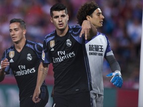 FILE - A Saturday May 6, 2017 file photo of Real Madrid's Alvaro Morata, center, celebrating scoring his goal against Granada during a Spanish La Liga soccer match between Granada and Real Madrid in Granada, Spain. Chelsea is set to strengthen its attacking options for its Premier League title defense by signing Alvaro Morata from Real Madrid. The London club said Wednesday, July 19, 2017, it has agreed terms with Madrid to sign the 24-year-old striker. (AP Photo/Daniel Tejedor, File)
