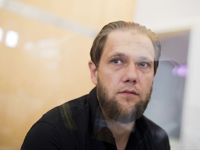 German Islamic radical Sven Lau stands in the security wing at the state court in  Duesseldorf, Germany, Wednesday, July 26, 2017. The court has convicted one of Germany's most prominent Islamic radicals of supporting a terrorist organization and sentenced him to 5 and a half years in prison. (Rolf Vennenbernd/dpa via AP)