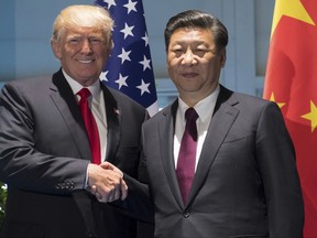 US President Donald Trump and Chinese President Xi Jinping, right, shake hands as they arrive for a meeting on the sidelines of the G-20 Summit in Hamburg, Germany, Saturday, July 8, 2017.  (Saul Loeb/Pool Photo via AP)