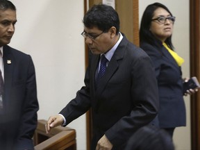 Prosecutor German Juarez, center, arrives to court, where he asked that former president Ollanta Humala and his wife Nadine Heredia, be placed under arrest, in Lima, Peru, Wednesday, June 12, 2017. Prosecutors in Peru have requested the arrest of former President Humala who governed Peru between 2011 and 2016 and his wife Nadine Heredia on money laundering and conspiracy charges tied to a corruption scandal involving Brazilian construction giant Odebrecht. (AP Photo/Martin Mejia)