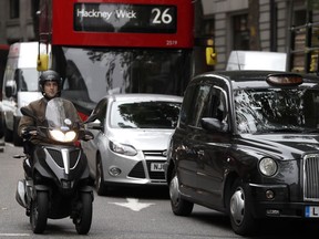 Vehicles drive in central London, Wednesday, July 26, 2017. To control air pollution, new diesel and petrol cars and vans could be banned in the UK from 2040. (AP Photo/Kirsty Wigglesworth)