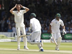 England's Stuart Broad reacts in frustration after being hit for four by South Africa's Quinton de Kock, second left, as Vernon Philander, right, runs during the first test between England and South Africa at Lord's cricket ground in London, Saturday, July 8, 2017. (AP Photo/Matt Dunham)