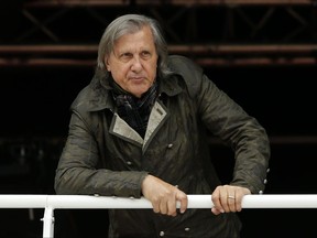 FILE - In this Monday, May 23, 2016 file picture, former Romanian tennis ace Ilie Nastase watches a match of the French Open tennis tournament at the Roland Garros stadium, in Paris, France.  Ilie Nasatse  on Friday July 21, 2017 has been banned from the Fed Cup and Davis Cup until 2019 because of his foul-mouthed comments and bad behavior as Romania's captain during a Fed Cup match against Britain. The International Tennis Federation also said the 1973 French Open champion will not be able to work in an official capacity for a further two years. (AP Photo/Alastair Grant, File)