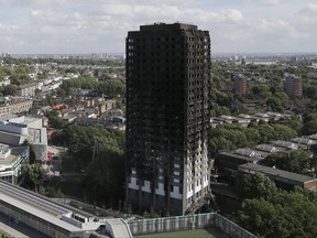 FILE - This is a Thursday, June 15, 2017   file photo of The scorched facade of the Grenfell Tower in London after a massive fire raced through the 24-storey high-rise apartment building in west London. British police have described the painstaking work of recovering remains from a burnt-out London high-rise, four weeks after the disaster killed at least 80 people. The Metropolitan Police force says it will take months to identify all the victims, and the agonizing wait has provoked anger and dismay from victim's families. (AP Photo/Frank Augstein/File)