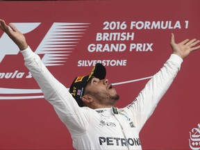 FILE - In this file photo dated Sunday, July 10, 2016, Britain's Mercedes driver Lewis Hamilton celebrates on the podium after winning the British Formula One Grand Prix at the Silverstone racetrack, Silverstone, England. The future of the British Grand Prix at Silverstone is under threat after the circuit's owners, British Racing Drivers' Club triggered a break clause in its contract, saying it lost 2.8 million pounds (now about $3.5 million) in 2015, and 2019 will be the last unless F1 owner Liberty reduces the race fee. (AP Photo/Luca Bruno, FILE)