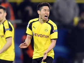 FILE - In this Wednesday, April 12, 2017 file photo, Dortmund's Shinji Kagawa celebrates after scoring his side's second goal during the Champions League quarterfinal first leg soccer match between Borussia Dortmund and AS Monaco in Dortmund, Germany. Japan star Shinji Kagawa has extended his contract with Borussia Dortmund contract by two years until June 2020. (AP Photo/Martin Meissner, File)