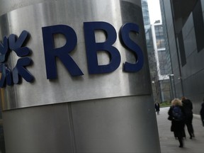 FILE - This is a Thursday, Jan. 26, 2017 file photo of People as they walk past one of the headquarters buildings showing the logo of the Royal Bank of Scotland in London. Royal Bank of Scotland said wednesday july 12, 2017 that it has reached a $5.5 billion settlement in the United States over mortgage-backed securities issued before the financial crisis.  (AP Photo/Alastair Grant/File)