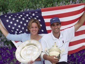 FILE - In this  Sunday, July 4, 1999 file photo, Americans Lindsay Davenport, left, and Pete Sampras pose with their trophies and an American flag following their victories in the Women's and Men's Singles at Wimbledon. Three-time major champion and former No. 1 Lindsay Davenport of the U.S will serve as a "legend ambassador" for the WTA Finals, announced by the WTA on Thursday July 6, 2017, which will be held in Singapore from Oct. 22-29. (AP Photo/Adam Butler, File)