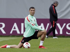 FILE - In this file photo dated Monday, June 26, 2017, Portugal's Cristiano Ronaldo stretches during a training session in St. Petersburg, Russia.  Spain's tax authority confirmed Wednesday July 12, 2017, that customs agents have boarded and carried out an inspection of a yacht rented by Portugal soccer captain Cristiano Ronaldo, adding that the inspection targeted the boat's owner, not Ronaldo as its renter. (AP Photo/Dmitri Lovetsky, FILE)