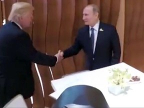 In this image taken from video U.S. President Donald Trump, left, shakes hand with the Russian President Vladimir Putin during the G20 summit in Hamburg Germany, Friday July 7, 2017. (Steffen Kugler/German Government via AP)