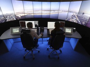 FILE - This is a May 19, 2017  file photo of National Air Traffic Services personnel giving a demonstration in the operations room at National Air Traffic Services in Swanwick southern England. Britain is poised to handle a record number of flights in its increasingly crowded skies. The NATS air traffic control agency said it expects to handle some 8,800 flights Friday, in what is expected to be the peak day of the busy summer travel season. (Andrew Matthews/PA File via AP)