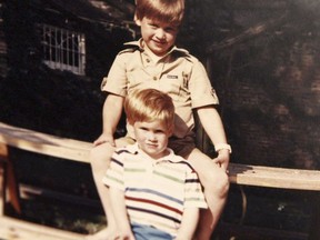 In this photo made available by Kensington Palace from the personal photo album of the late Diana, Princess of Wales, Prince William and Prince Harry sit on a picnic bench together.