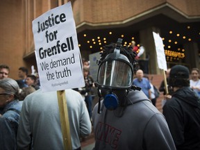 People protest ahead of a meeting of Kensington and Chelsea Council at Kensington Town Hall in west London, Wednesday July 19, 2017, the local authority in control of response to the recent Grenfell Tower fire.   The fire at the Grenfell Tower residential bloc left dozens dead (Ben Stevens/PA via AP)