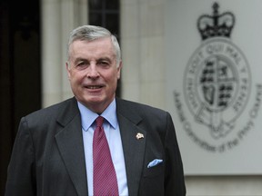 FILE - In this file photo dated March 8, 2017,  ex-cavalry officer now retired John Walker, poses outside Britain's highest court in London.  The Supreme Court ordered Wednesday July 12, 2017, that if John Walker died, his husband would be entitled to a spouse's pension, provided they stay married, ending their discrimination and securing the same occupational pension rights for a gay couple as a heterosexual couple. (David Mirzoeff/PA FILE via AP)
