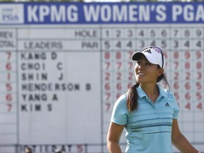 Danielle Kang smile after her birdie on the 18th green during the third round of the Women's PGA Championship golf tournament at Olympia Fields Country Club, Saturday, July 1, 2017, in Olympia Fields, Ill. (AP Photo/Charles Rex Arbogast)