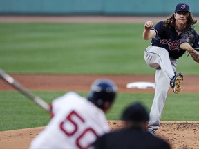 Cleveland Indians starting pitcher Mike Clevinger, top right, strikes out Boston Red Sox's Mookie Betts, front left, during the first inning of a baseball game at Fenway Park, Monday, July 31, 2017, in Boston. (AP Photo/Charles Krupa)