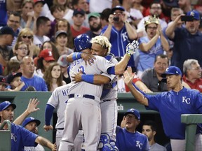 Kansas City Royals' Mike Moustakas (8) is embraced by Salvador Perez after his three-run home run off Boston Red Sox starting pitcher Rick Porcello during the fourth inning of a baseball game at Fenway Park, Friday, July 28, 2017, in Boston. (AP Photo/Charles Krupa)