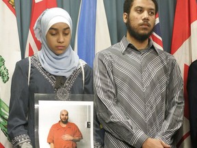 Afnan Jaballah, 13, holds a photo of her father, Mahmoud Jaballah, as her brother Ahmad Jaballah looks on during a press conference on Parliament Hill in Ottawa, on Friday, Feb. 2, 2007. Strict release conditions need to continue for an Egyptian man the federal government has long branded as a potentially dangerous terrorist, a Federal Court judge has ruled. THE CANADIAN PRESS/Patrick Doyle